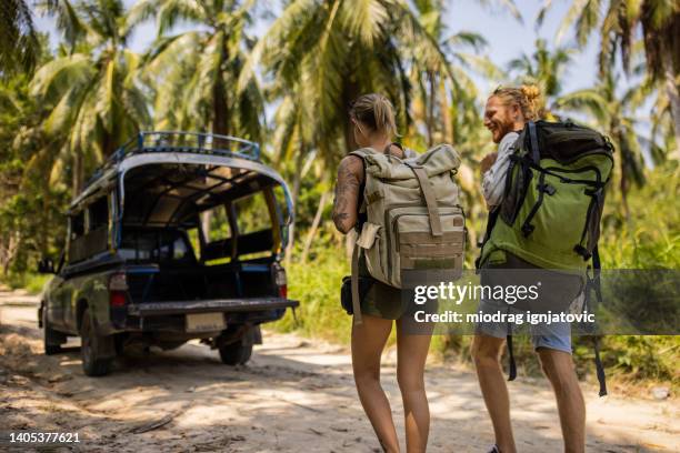 young caucasian couple walking toward off road taxi - thailand tourist stock pictures, royalty-free photos & images