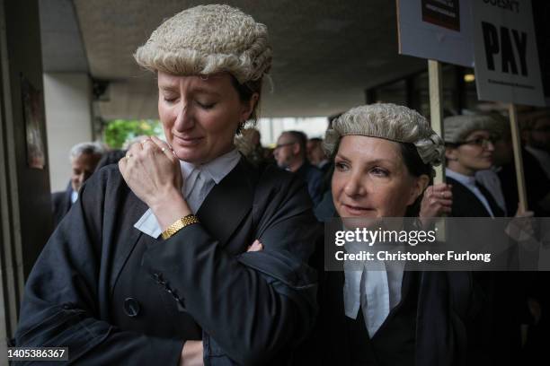 Barristers become emotional after listening to speeches during a protest over funding outside Manchester Crown Court on June 27, 2022 in Manchester,...