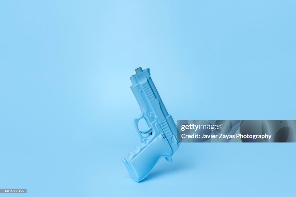 Blue Handgun On Blue Background