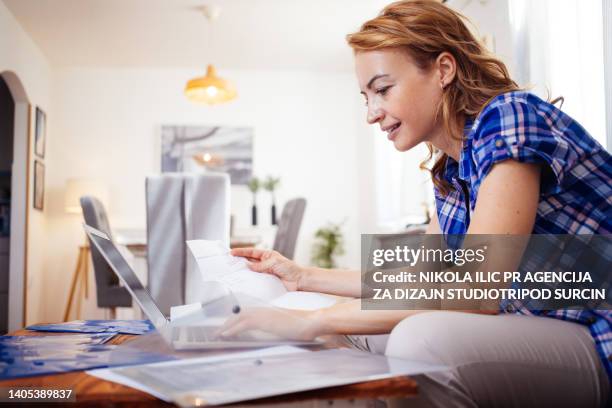 woman paying bills and working online stock photo - credit history stock pictures, royalty-free photos & images