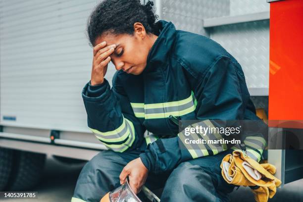 depressed firefighter after rescue operation - firefighter uniform stock pictures, royalty-free photos & images