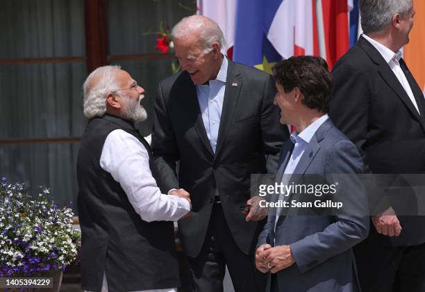 President Joe Biden greets Indian Prime Minister Narendra Modi as Canadian Prime Minister Justin Trudeau looks on prior to a group photo of the...