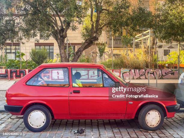 red ford car model fiesta parked in the street - ford fiesta cars stock pictures, royalty-free photos & images