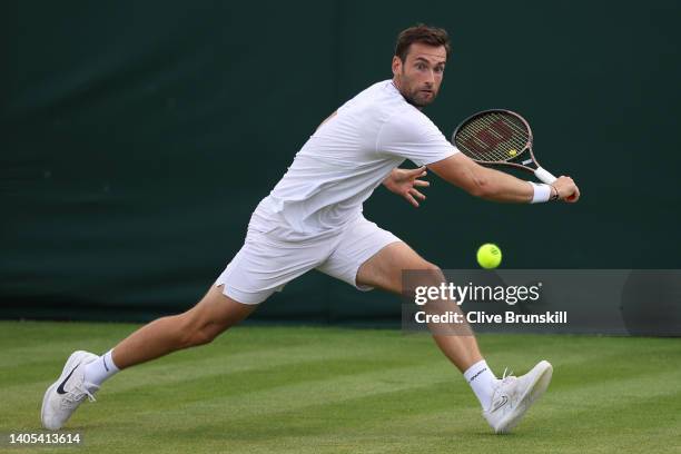 Quentin Halys of France plays a backhand against Benoit Paire of France during the Men's Singles First Round match during Day One of The...