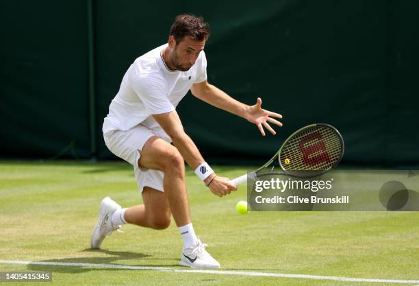 Quentin Halys of France plays a backhand against Benoit Paire of France during the Men's Singles First Round match during Day One of The...