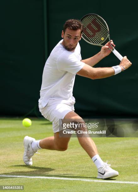 Quentin Halys of France plays a backhand against Benoit Paire of France during the Men's Singles First Round match during Day One of The...