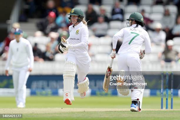 Anneke Bosch of South Africa exchanges runs with Marizanne Kap during Day One of the First Test Match between England Women and South Africa Women at...