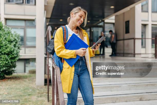 chatting with friends while waiting for the next class - female rain coat bildbanksfoton och bilder