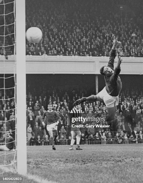 Jim Furnell, Goalkeeper for Arsenal Football Club dives in an attempt to stop the opening goal by Bobby Hope of West Bromwich Albion during their...