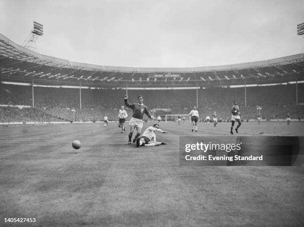 French footballer Raymond Kopa under pressure from British footballer Jimmy Armfield during the centenary match between England and a Rest of the...