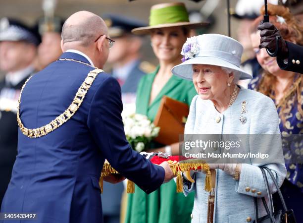 Lord Provost Robert Aldridge presents Queen Elizabeth II with the keys to the city of Edinburgh during The Ceremony of the Keys on the forecourt of...