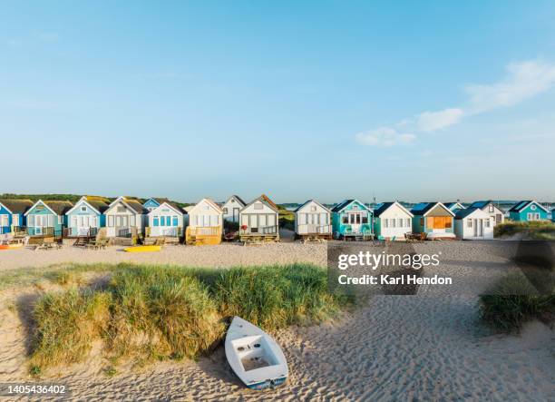 a dawn view of colourful beach huts, uk - beach holiday uk stock pictures, royalty-free photos & images