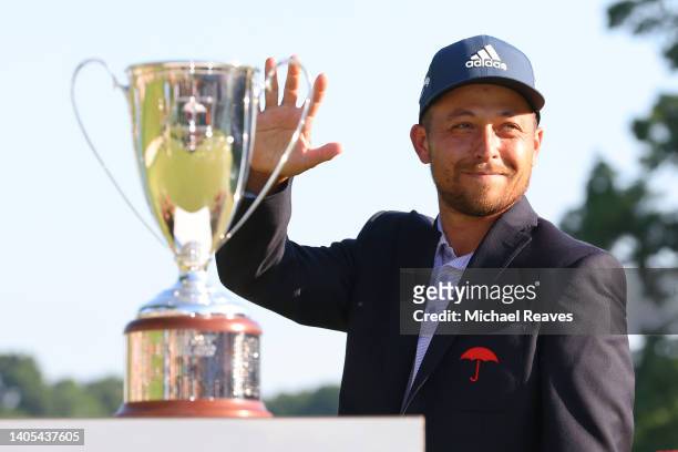 Xander Schauffele of the United States reacts during the trophy presentation after winning the Travelers Championship at TPC River Highlands on June...