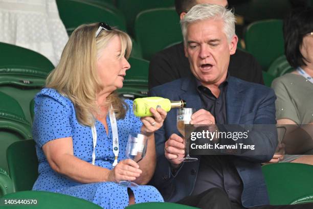 Stephanie Lowe and Phillip Schofield, who visited the Lanson Champagne Suite, attend Day One of Wimbledon 2022 at the All England Lawn Tennis and...