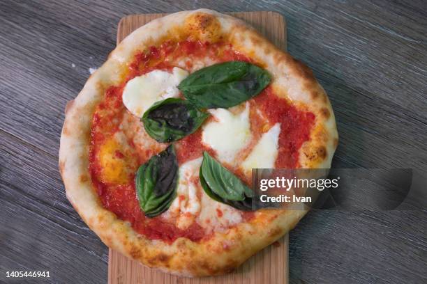 fresh margaret pizza put on wooden board - cheese pizza stock-fotos und bilder