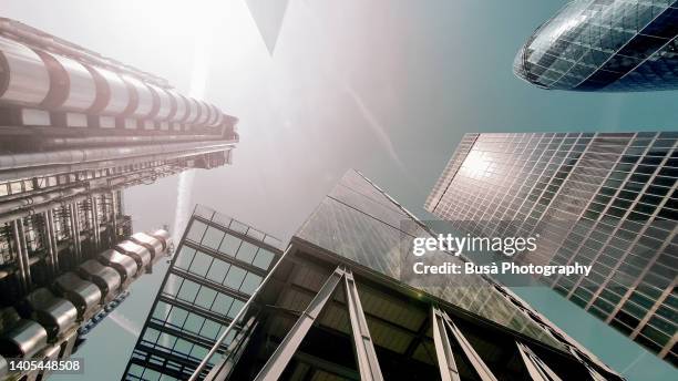 view from below of highrise office towers in the city of london: the leadenhall building, the gherkin or 30 st mary axe, and the lloyd's building. london, england, uk - lloyds of london stock-fotos und bilder