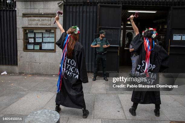 Activists wear judge's robe reading 'Stop sexist justice' as they demonstrate outside the US Embassy against the US Supreme Court decision to...
