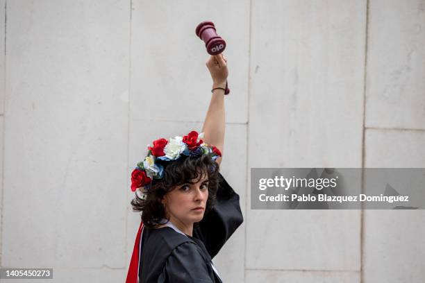 Activist rises her fist holding a toy gavel as she demonstrates outside the US Embassy against the US Supreme Court decision to overturn abortion...