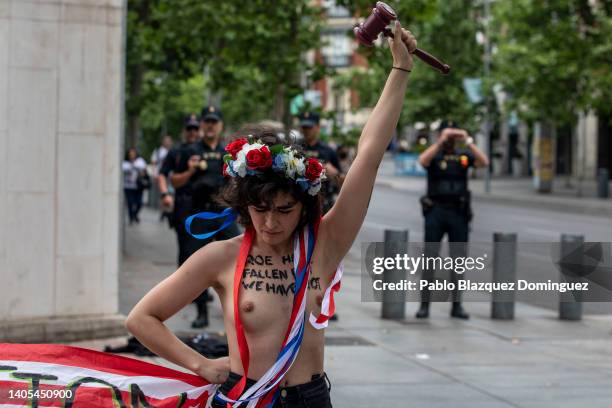 Activist rises her fist holding a toy gavel as she demonstrates outside the US Embassy against the US Supreme Court decision to overturn abortion...