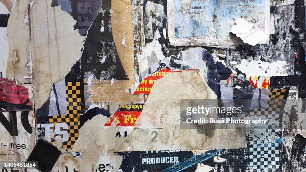 scratched layers of posters and placards on a street wall in dalston, london, england, uk - punk stockfoto's en -beelden