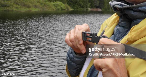 close up of female hiker closing backpack straps - buckle fotografías e imágenes de stock
