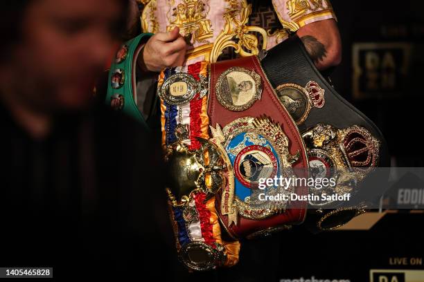 Boxer Canelo Alvarez poses with his championship belts at the end of the press conference during the press tour for his fight against Gennady...