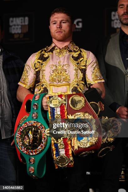 Boxer Canelo Alvarez poses with his championship belts at the end of the press conference during the press tour for his fight against Gennady...