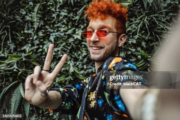 portrait of a young stylish and fashionable gay man taking selfie - cat hipster no stock pictures, royalty-free photos & images