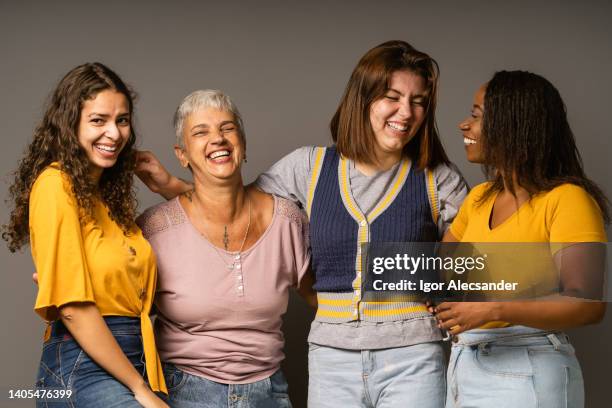 group of playful women in studio - menselijke leeftijd stockfoto's en -beelden