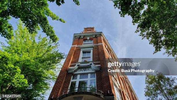 brick facade of residential corner building in london, england - buildings looking up stock pictures, royalty-free photos & images