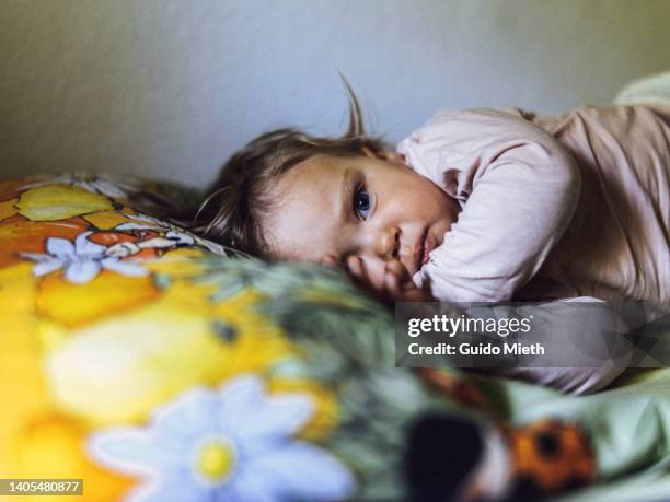 beautiful toddler girl awaking after napping. - sleeping toddler bed stock-fotos und bilder