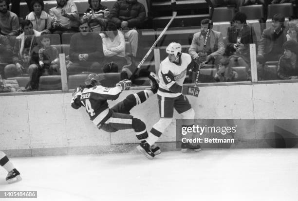 Red Wing Ted Nolan looks back to see Maple Leafs' Miroslav Frycer take a tumble after checking him in the first period of the Toronto-Detroit game....