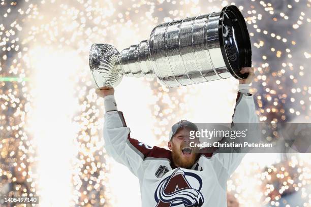 Gabriel Landeskog of the Colorado Avalanche lifts the Stanley Cup in celebration after Game Six of the 2022 NHL Stanley Cup Final at Amalie Arena on...