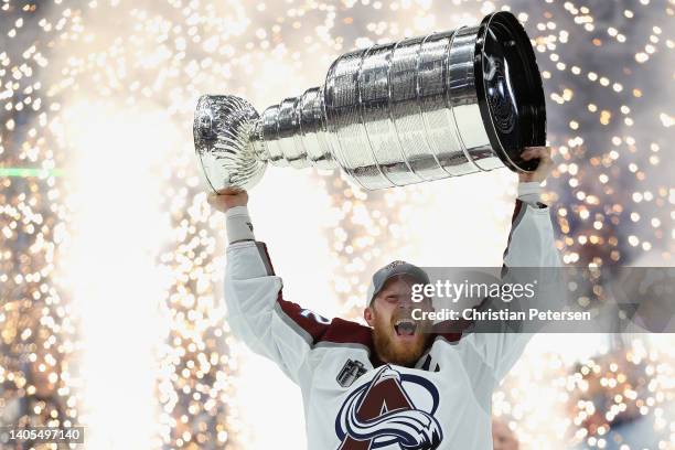 Gabriel Landeskog of the Colorado Avalanche lifts the Stanley Cup in celebration after Game Six of the 2022 NHL Stanley Cup Final at Amalie Arena on...