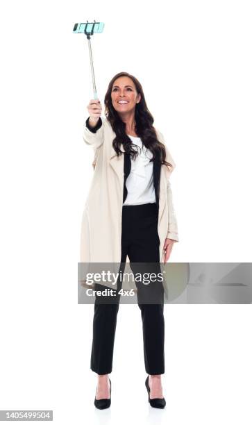 caucasian young women businesswoman standing in front of white background wearing businesswear - taking selfie white background stock pictures, royalty-free photos & images