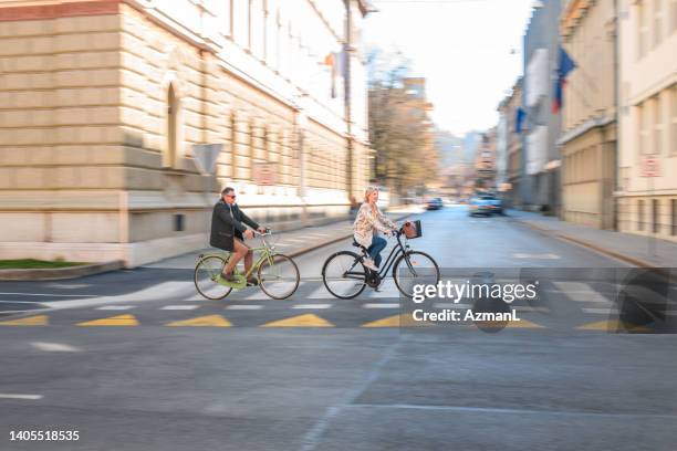 portrait of white senior couple outside enjoying time together - couple crossing street stock pictures, royalty-free photos & images