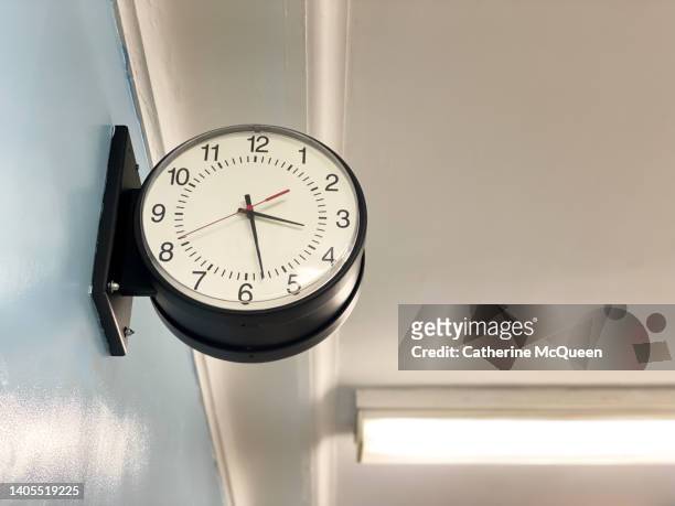 traditional school hallway clock - arriving late class stockfoto's en -beelden