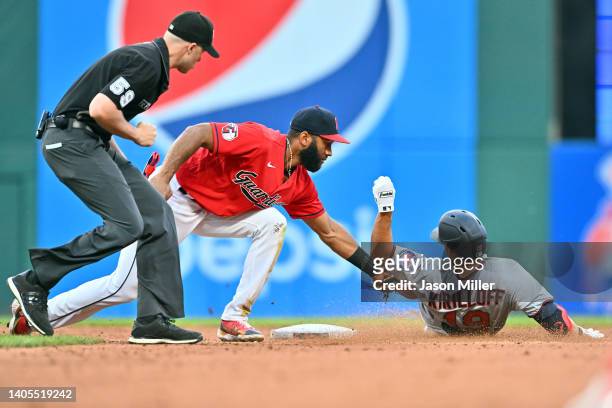 Umpire Nic Lentz watches as Shortstop Amed Rosario of the Cleveland Guardians tags out Alex Kirilloff of the Minnesota Twins at second during the...
