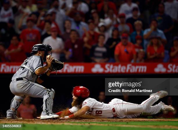 Brandon Marsh of the Los Angeles Angels scores a run in front of Seby Zavala of the Chicago White Sox in the seventh inning at Angel Stadium of...