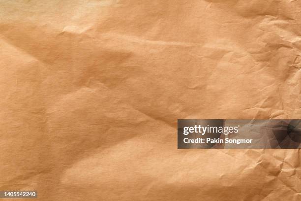 dark moderate orange color eco recycled kraft paper sheet texture cardboard background. - grocery bag stock pictures, royalty-free photos & images