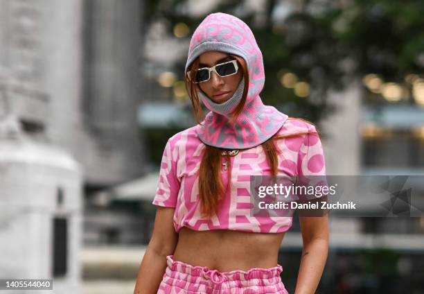 Kat Gosik is seen wearing a pink Marc Jacobs top and pants and pink Marc Jacobs balaclava outside the Marc Jacobs show on June 27, 2022 in New York...
