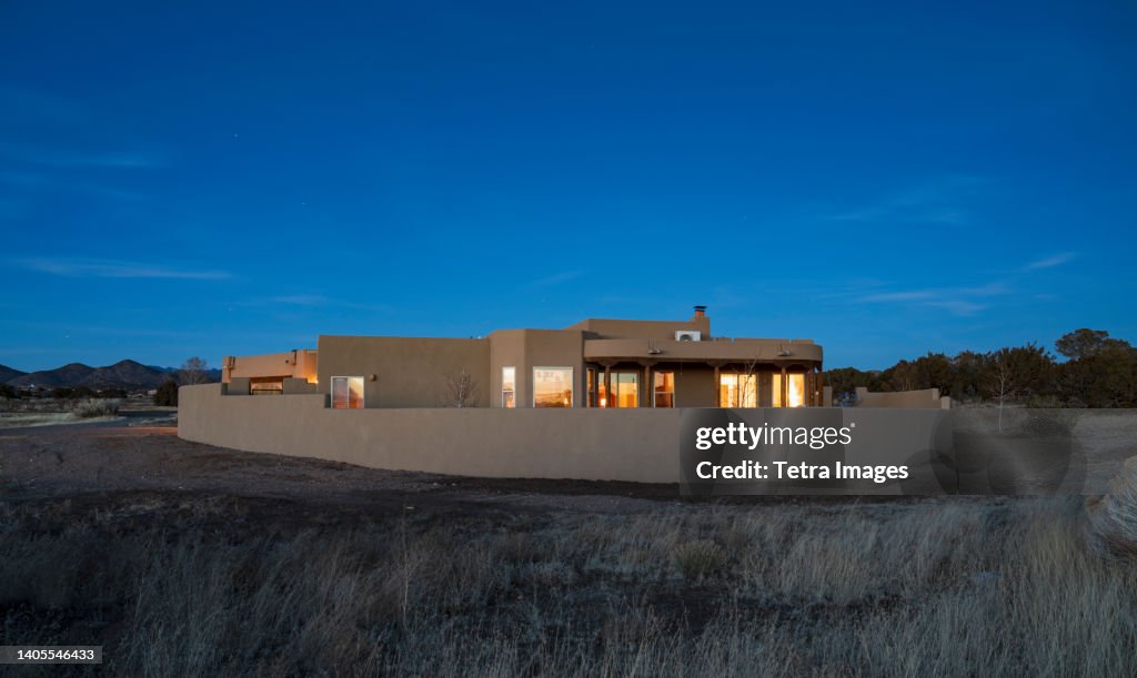USA, New Mexico, Santa Fe, Pueblo style house in landscape at dusk
