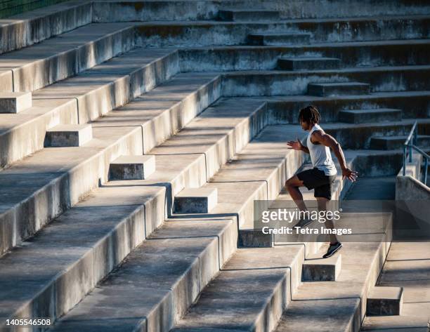 athletic man running up steps - cardio ストックフォトと画像