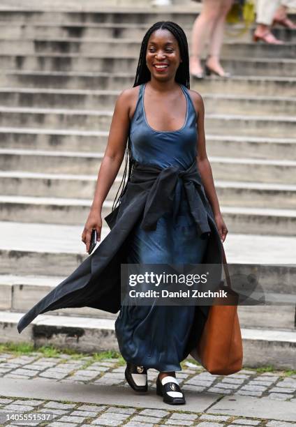 Rajni Jacques is seen wearing a blue dress and gray coat outside the Marc Jacobs show on June 27, 2022 in New York City.