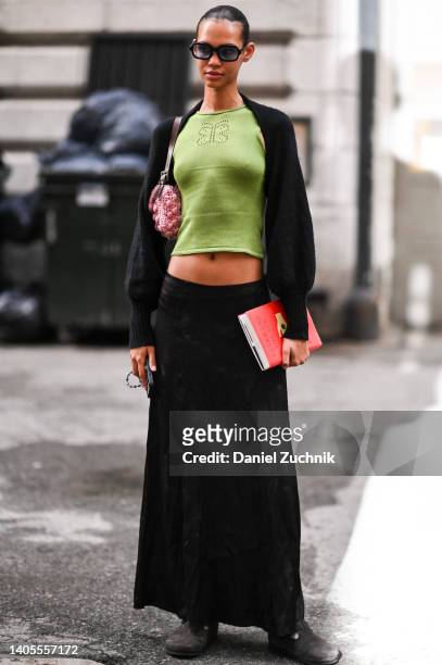Model Jordan Daniels seen wearing a black sweater, green top, black skirt and pink bag with black sunglasses outside the Marc Jacobs show on June 27,...