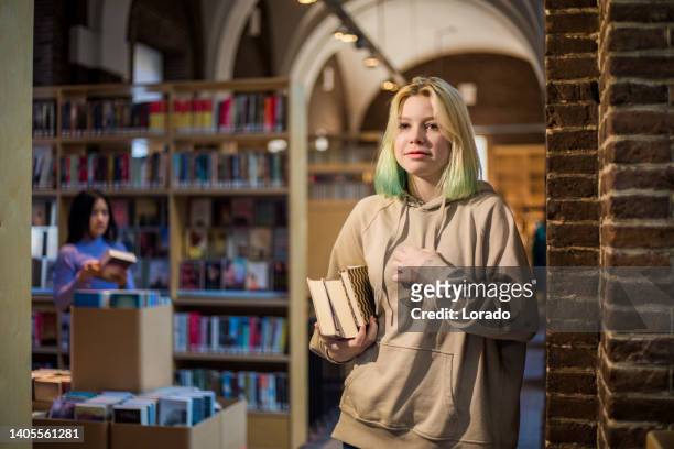 beautiful teenage female student studying in a public library - endast en tonårsflicka bildbanksfoton och bilder