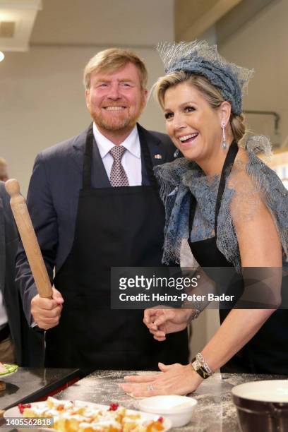 King Willem-Alexander of The Netherlands and Queen Maxima of The Netherlands cook during a visit of the community cooking project at Brotfabrik on...