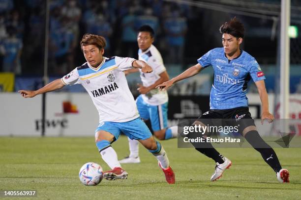 Shota Kaneko of Jubilo Iwata in action under pressure from Tatsuki Seko of Kawasaki Frontale compete for the ball during the J.LEAGUE Meiji Yasuda J1...