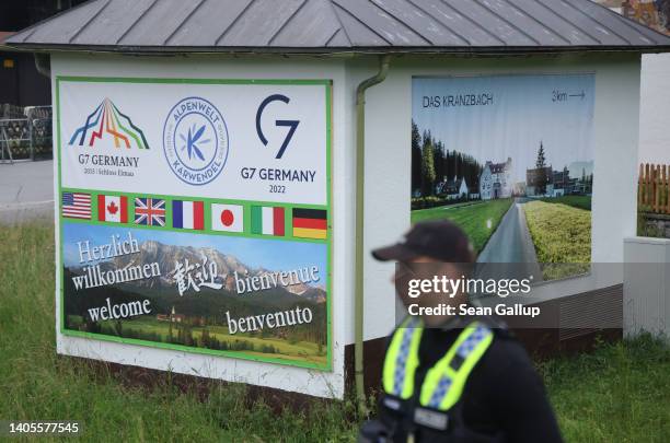 Policeman stands next to a billboard for the G7 summit on the third and final day of the nearby G7 summit at Schloss Elmau on June 28, 2022 near...