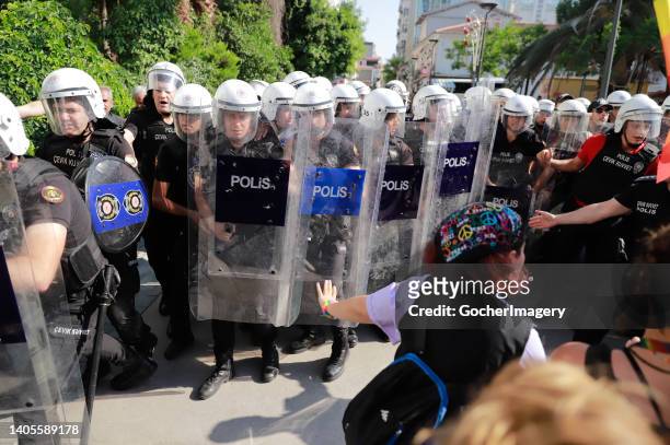 Members of the LGBT community clash with riot police officers during the 10th Izmir LGBTI+ Pride March in Izmir, Turkey, on Sunday, June 26, 2022.